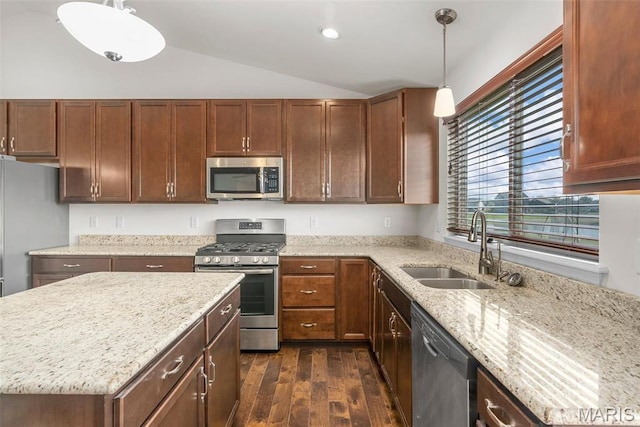 kitchen with stainless steel appliances, a sink, dark wood-type flooring, lofted ceiling, and light stone countertops