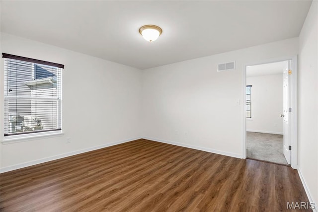 empty room with wood finished floors and baseboards