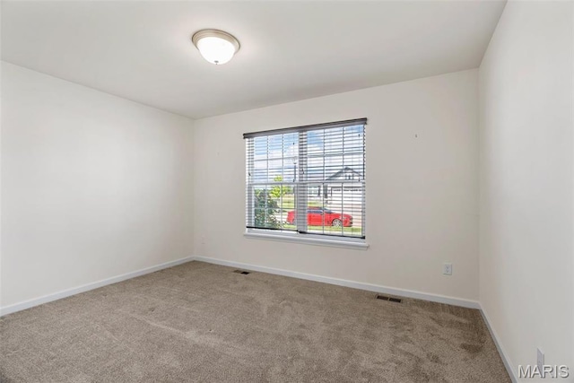 unfurnished room featuring carpet flooring and baseboards