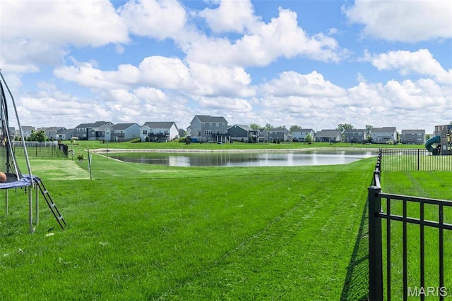 view of community with a trampoline, a water view, and a residential view