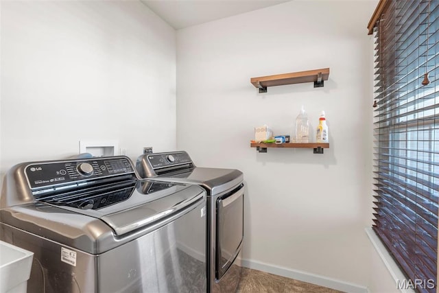 laundry area featuring washer and dryer and baseboards
