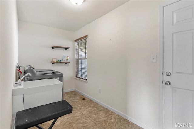 washroom featuring independent washer and dryer and baseboards