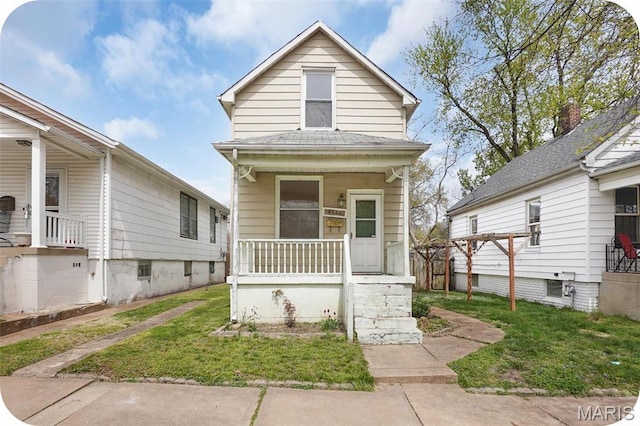 4171 Burgen Ave, Saint Louis, MO 63116 - shotgun-style home with a porch and a front yard