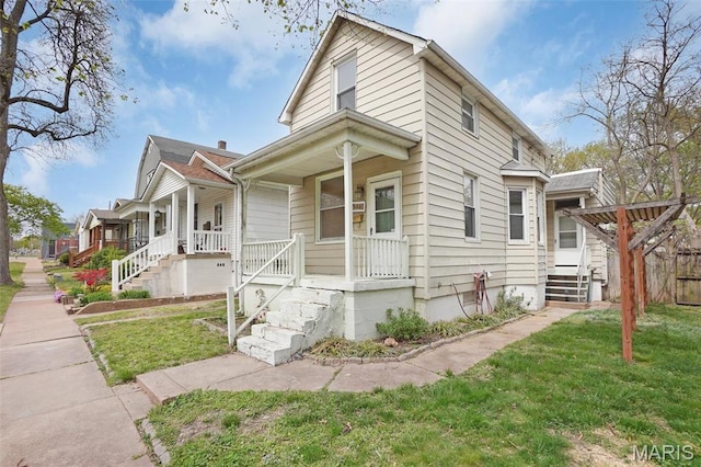 4171 Burgen Ave, Saint Louis, MO 63116 - view of front facade with a porch, a front lawn, and stairway