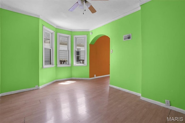 4171 Burgen Ave, Saint Louis, MO 63116 - empty room with arched walkways, ceiling fan, crown molding, baseboards, and wood finished floors