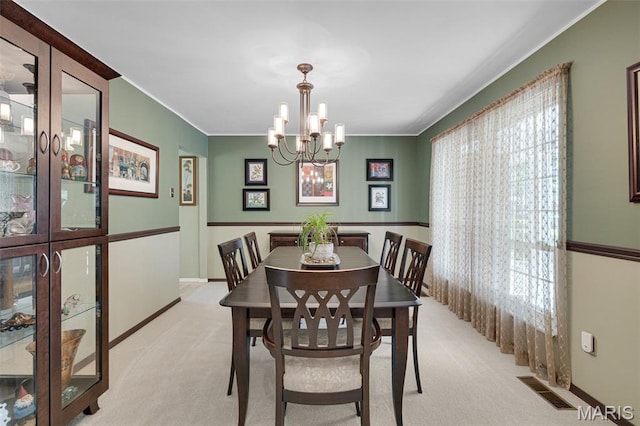 14710 Arbre Ln, Florissant, MO 63034 - dining space with light carpet, a chandelier, baseboards, and crown molding
