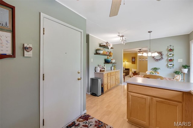14710 Arbre Ln, Florissant, MO 63034 - kitchen featuring light wood-type flooring, light countertops, a ceiling fan, decorative light fixtures, and a chandelier