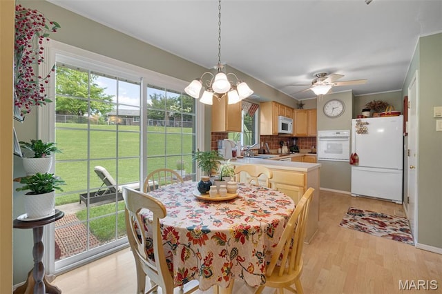 14710 Arbre Ln, Florissant, MO 63034 - dining area featuring light wood-type flooring, a chandelier, and a ceiling fan