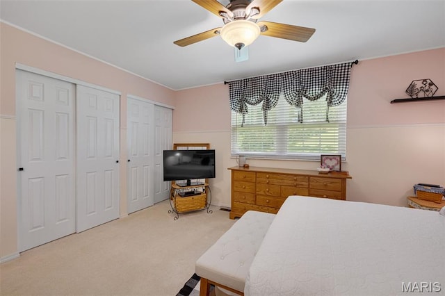 14710 Arbre Ln, Florissant, MO 63034 - bedroom featuring multiple closets, light carpet, and ceiling fan