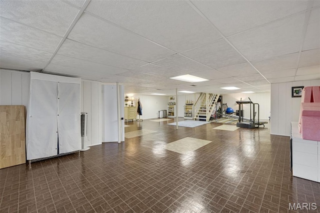 14710 Arbre Ln, Florissant, MO 63034 - finished basement with brick patterned flooring, a paneled ceiling, and stairs