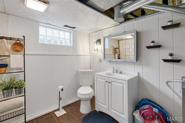 14710 Arbre Ln, Florissant, MO 63034 - bathroom featuring vanity, toilet, and brick patterned floors