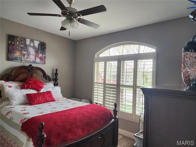 carpeted bedroom featuring baseboards and ceiling fan
