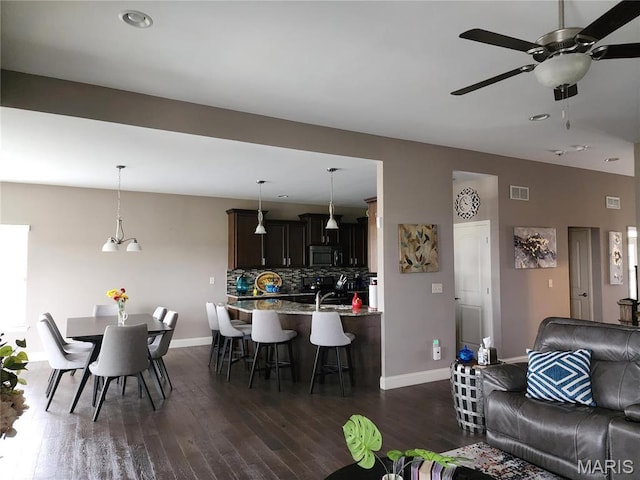 living room with baseboards, ceiling fan, dark wood-style flooring, and recessed lighting