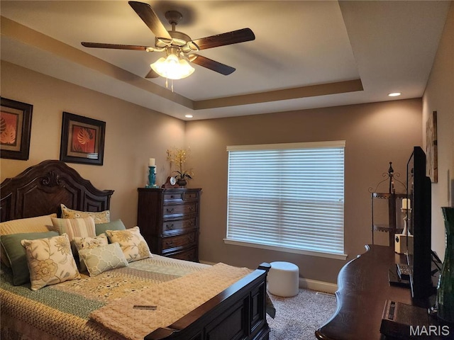 carpeted bedroom with recessed lighting, a raised ceiling, baseboards, and a ceiling fan