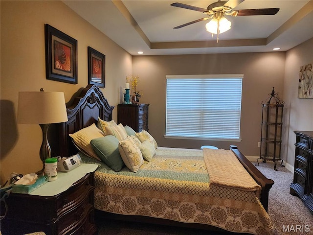 bedroom with carpet, a raised ceiling, baseboards, ceiling fan, and recessed lighting