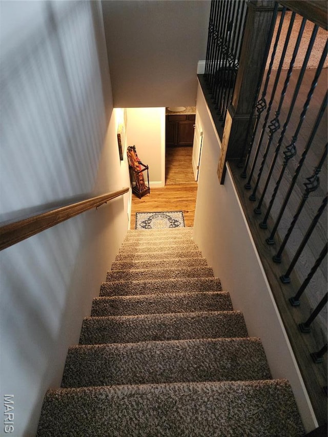 stairway with wood finished floors