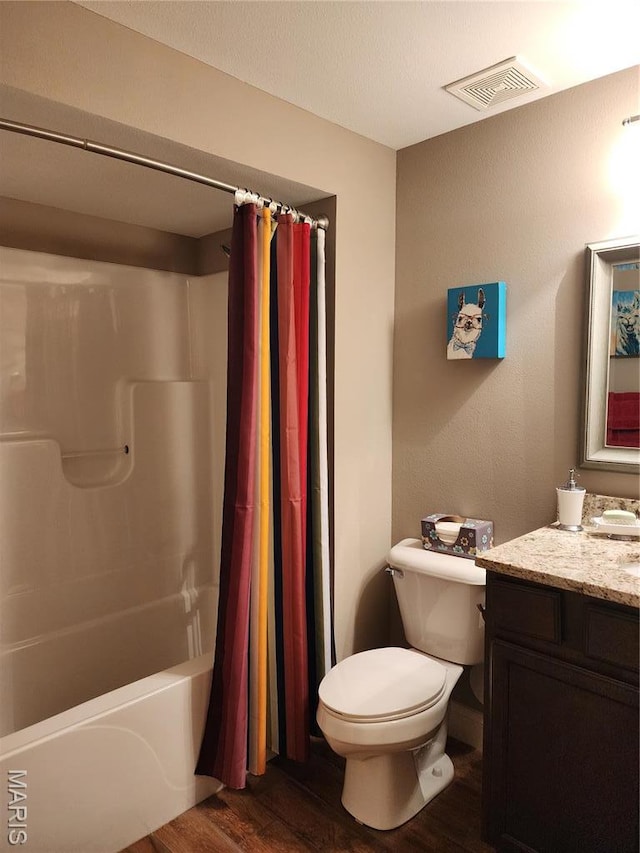 full bath featuring wood finished floors, toilet, vanity, and shower / bathtub combination with curtain