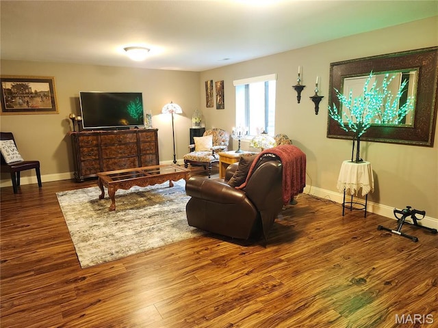 living area with wood finished floors and baseboards