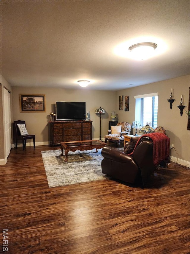 living room with dark wood-style floors and baseboards