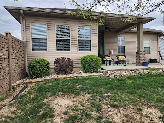 7466 Clarence Ct, Glen Carbon, IL 62034 - back of house featuring a ceiling fan, a patio area, and a yard