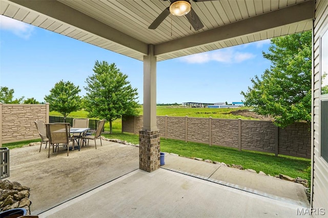 7466 Clarence Ct, Glen Carbon, IL 62034 - fenced backyard featuring outdoor dining space, ceiling fan, and a patio area