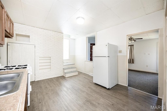 917 N Church St, Belleville, IL 62220 - kitchen with freestanding refrigerator, a ceiling fan, wood finished floors, wainscoting, and a sink