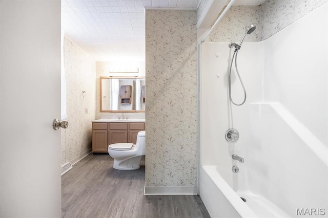 917 N Church St, Belleville, IL 62220 - bathroom with wood finished floors, vanity, toilet, baseboards, and bathtub / shower combination