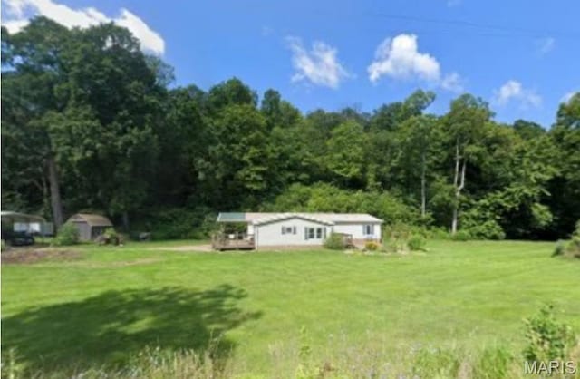 119 Bethel Rd, Hawk Point, MO 63349 - view of green lawn featuring a forest view and an outdoor structure