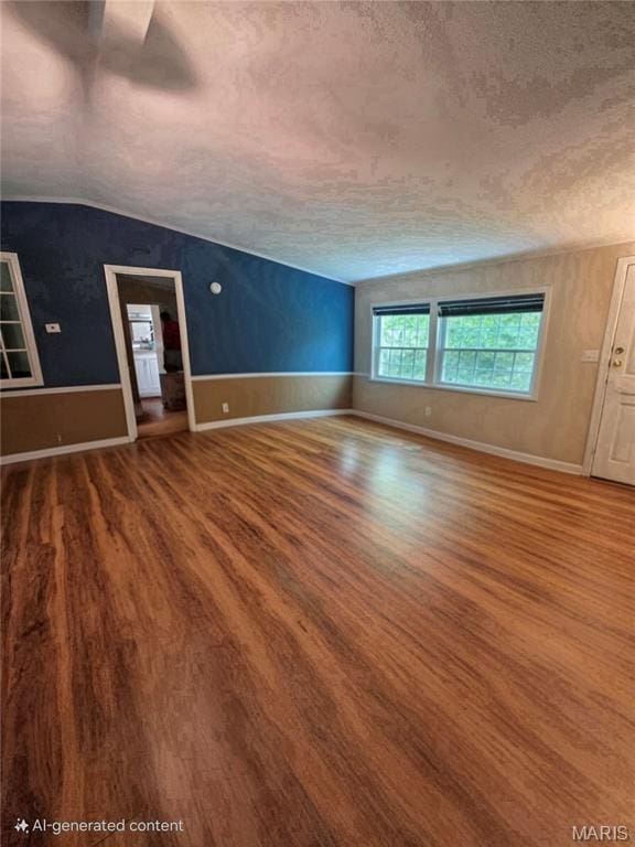 119 Bethel Rd, Hawk Point, MO 63349 - unfurnished living room featuring a textured ceiling, wood finished floors, lofted ceiling, and baseboards