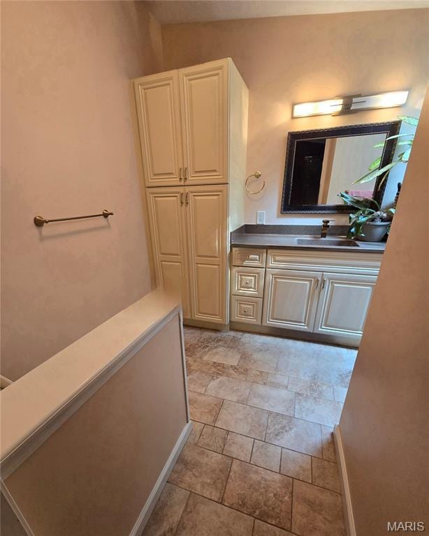 119 Bethel Rd, Hawk Point, MO 63349 - bathroom with vanity, stone finish flooring, and baseboards