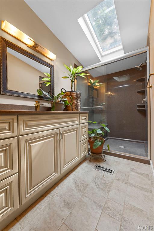 119 Bethel Rd, Hawk Point, MO 63349 - full bath with a skylight, vanity, a shower stall, and lofted ceiling