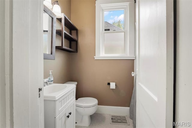 528 Hillsboro Ave, Edwardsville, IL 62025 - half bath with vanity, toilet, baseboards, and tile patterned floors