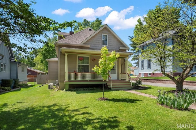 528 Hillsboro Ave, Edwardsville, IL 62025 - back of house featuring covered porch, a chimney, a yard, and roof with shingles