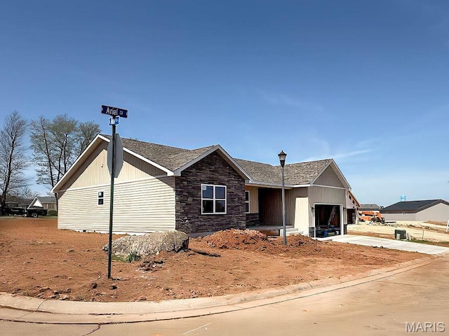 201 Ariel Ct, Desloge, MO 63601 - view of front of property featuring a garage, stone siding, and concrete driveway