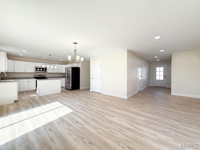 201 Ariel Ct, Desloge, MO 63601 - unfurnished living room featuring a chandelier, light wood-type flooring, and recessed lighting
