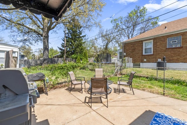 3644 Eminence Blvd, Saint Louis, MO 63114 - view of patio / terrace featuring a trampoline, a fenced backyard, central AC unit, and a grill