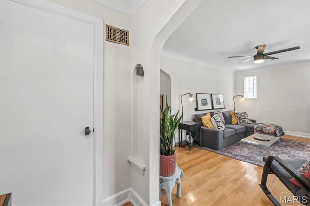3644 Eminence Blvd, Saint Louis, MO 63114 - living area with a ceiling fan, arched walkways, and wood finished floors