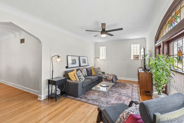 3644 Eminence Blvd, Saint Louis, MO 63114 - living area with wood finished floors, arched walkways, ceiling fan, and baseboards