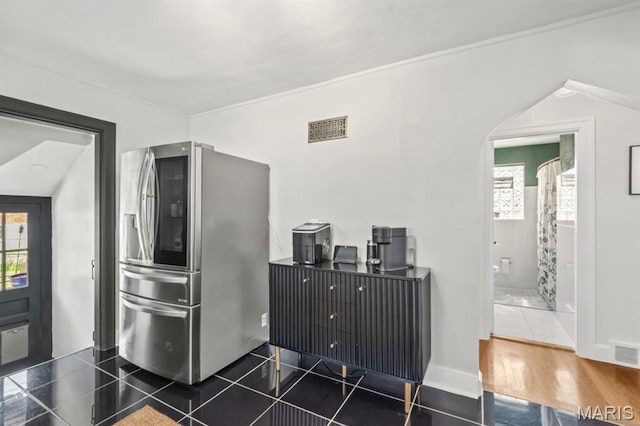 3644 Eminence Blvd, Saint Louis, MO 63114 - kitchen featuring stainless steel fridge with ice dispenser, arched walkways, and dark tile patterned flooring