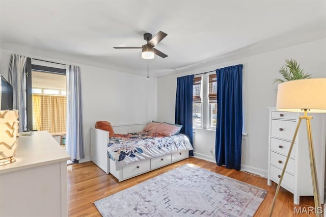 3644 Eminence Blvd, Saint Louis, MO 63114 - bedroom with multiple windows, light wood-style flooring, and a ceiling fan