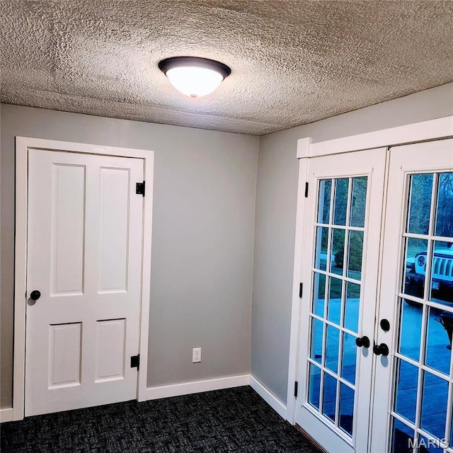 doorway to outside with french doors, dark carpet, baseboards, and a textured ceiling