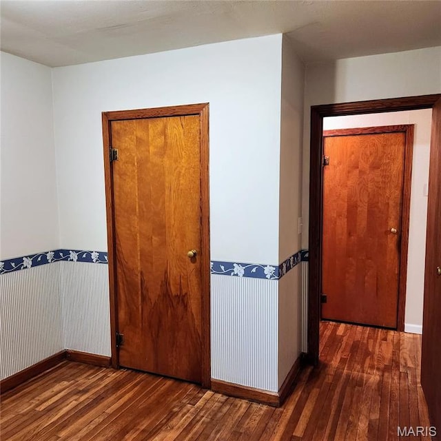 hall with hardwood / wood-style flooring and baseboards