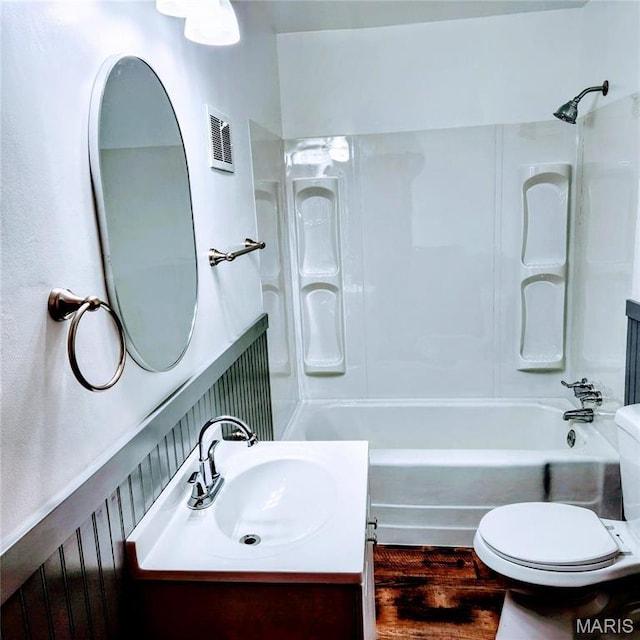 full bath with  shower combination, vanity, and toilet