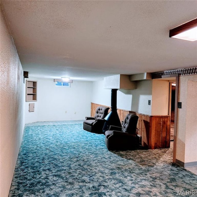 finished basement with carpet and a textured ceiling