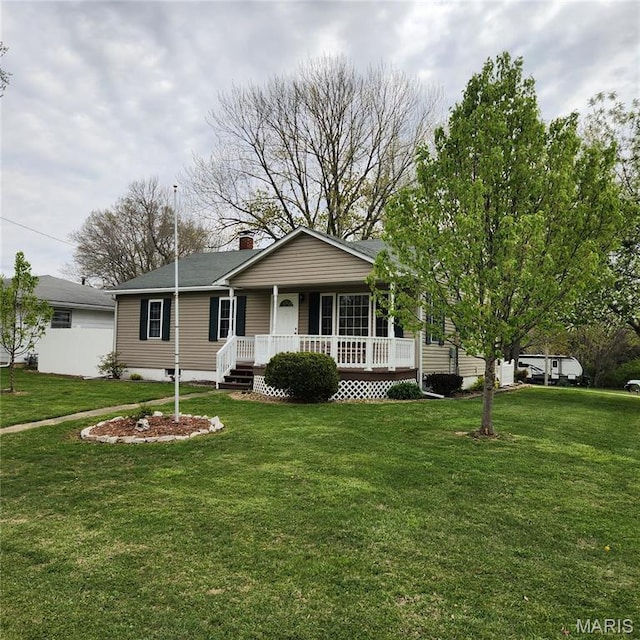 view of front facade featuring a porch, a front yard, and a chimney