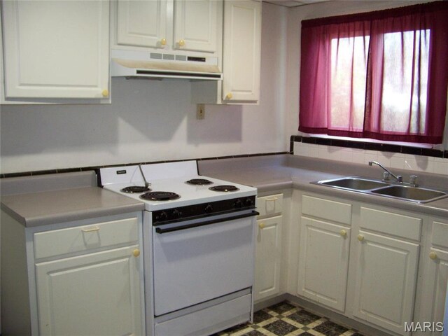 kitchen featuring white range with electric cooktop, under cabinet range hood, a sink, white cabinetry, and tile patterned floors
