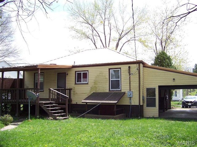 back of property with a lawn, a porch, and metal roof