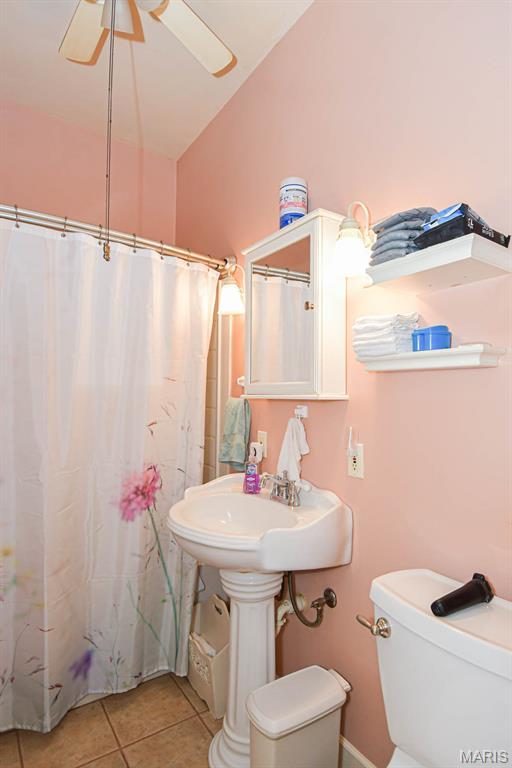 4207 Connecticut St, Saint Louis, MO 63116 - bathroom with lofted ceiling, tile patterned flooring, toilet, a shower with curtain, and a ceiling fan