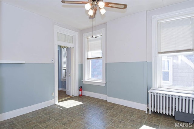 4207 Connecticut St, Saint Louis, MO 63116 - unfurnished room featuring radiator heating unit, a ceiling fan, and baseboards