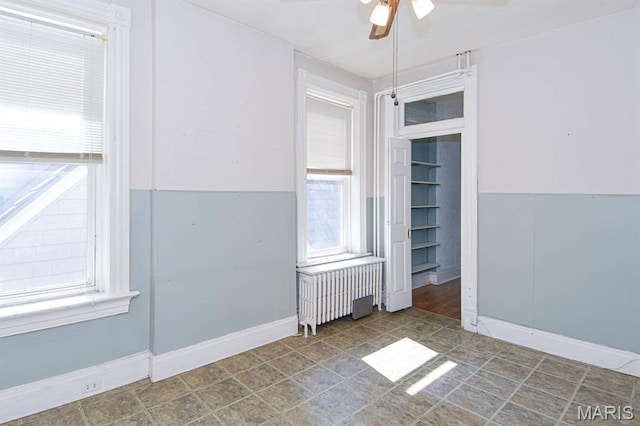 4207 Connecticut St, Saint Louis, MO 63116 - spare room featuring radiator heating unit, ceiling fan, plenty of natural light, and baseboards